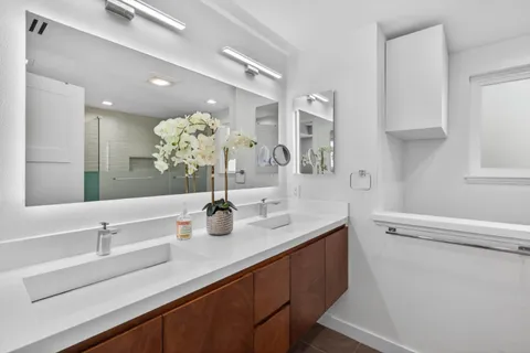 a bathroom with a sink a toilet and shower
