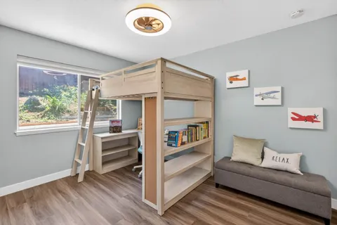 a view of a room with furniture and wooden floor