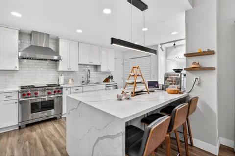 a kitchen with a stove a sink and a refrigerator