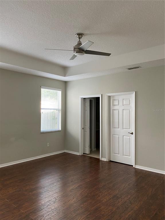 13638 Ancilla Boulevard Windermere, FL 34786 - Photo 13 of 16 a view of an empty room with wooden floor and a window