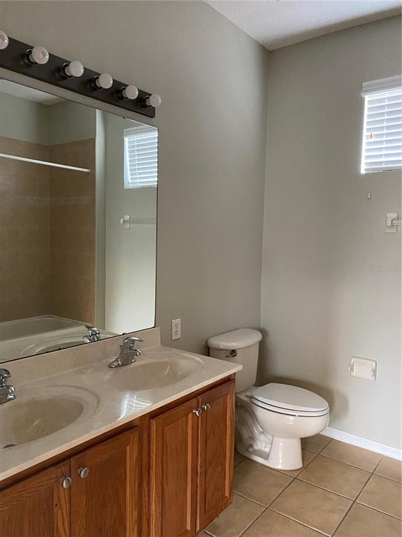 13638 Ancilla Boulevard Windermere, FL 34786 - Photo 9 of 16 a bathroom with a sink toilet and shower