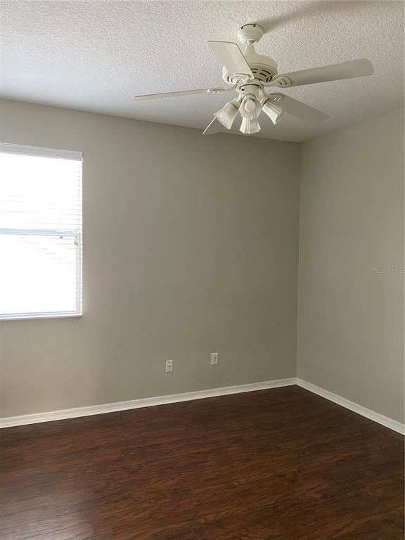 13638 Ancilla Boulevard Windermere, FL 34786 - Photo 10 of 16 wooden floor in an empty room with a window