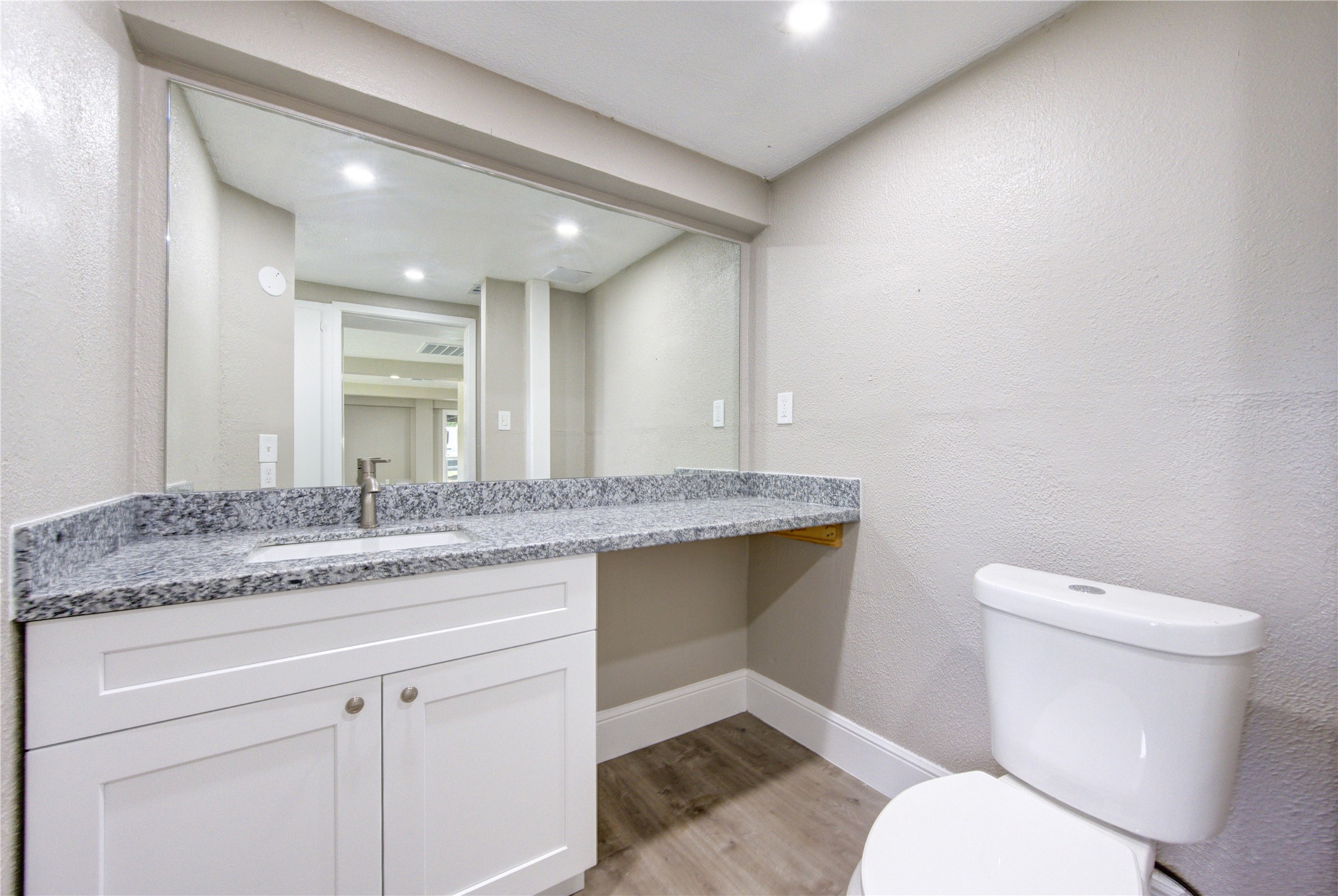 15170 McRae Lake Conroe, TX 77303 - Photo 11 of 25 a bathroom with a granite countertop toilet sink and mirror
