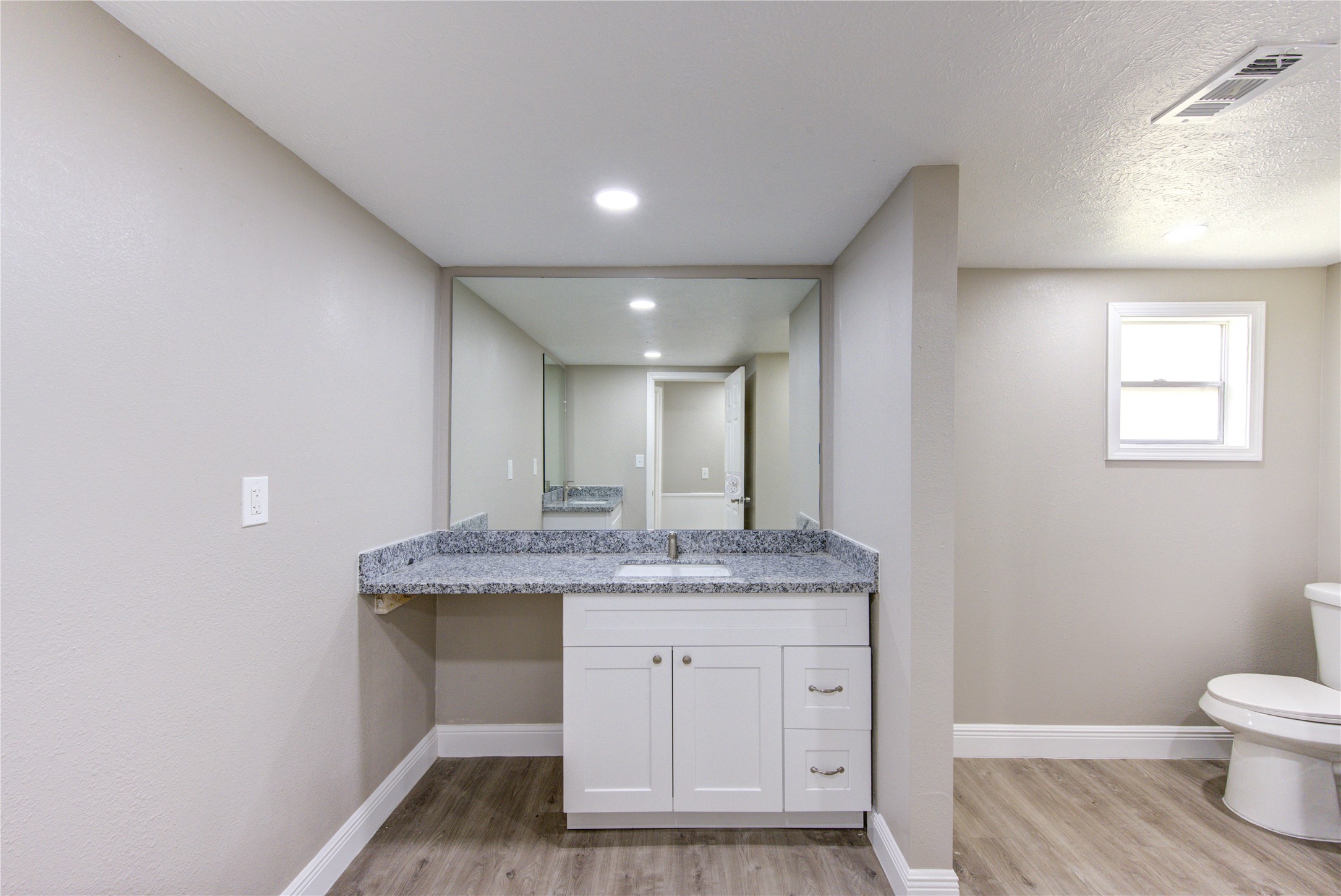 15170 McRae Lake Conroe, TX 77303 - Photo 24 of 25 a bathroom with a granite countertop sink and a mirror