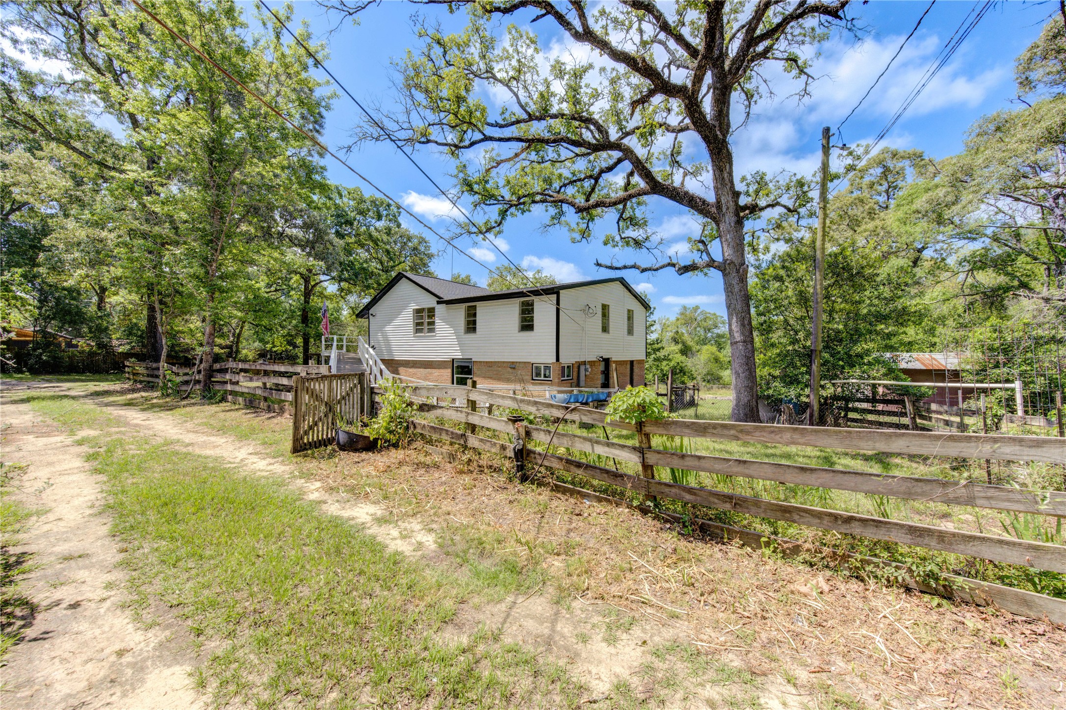 15170 McRae Lake Conroe, TX 77303 - Photo 4 of 25 a view of backyard of house with green space and seating area