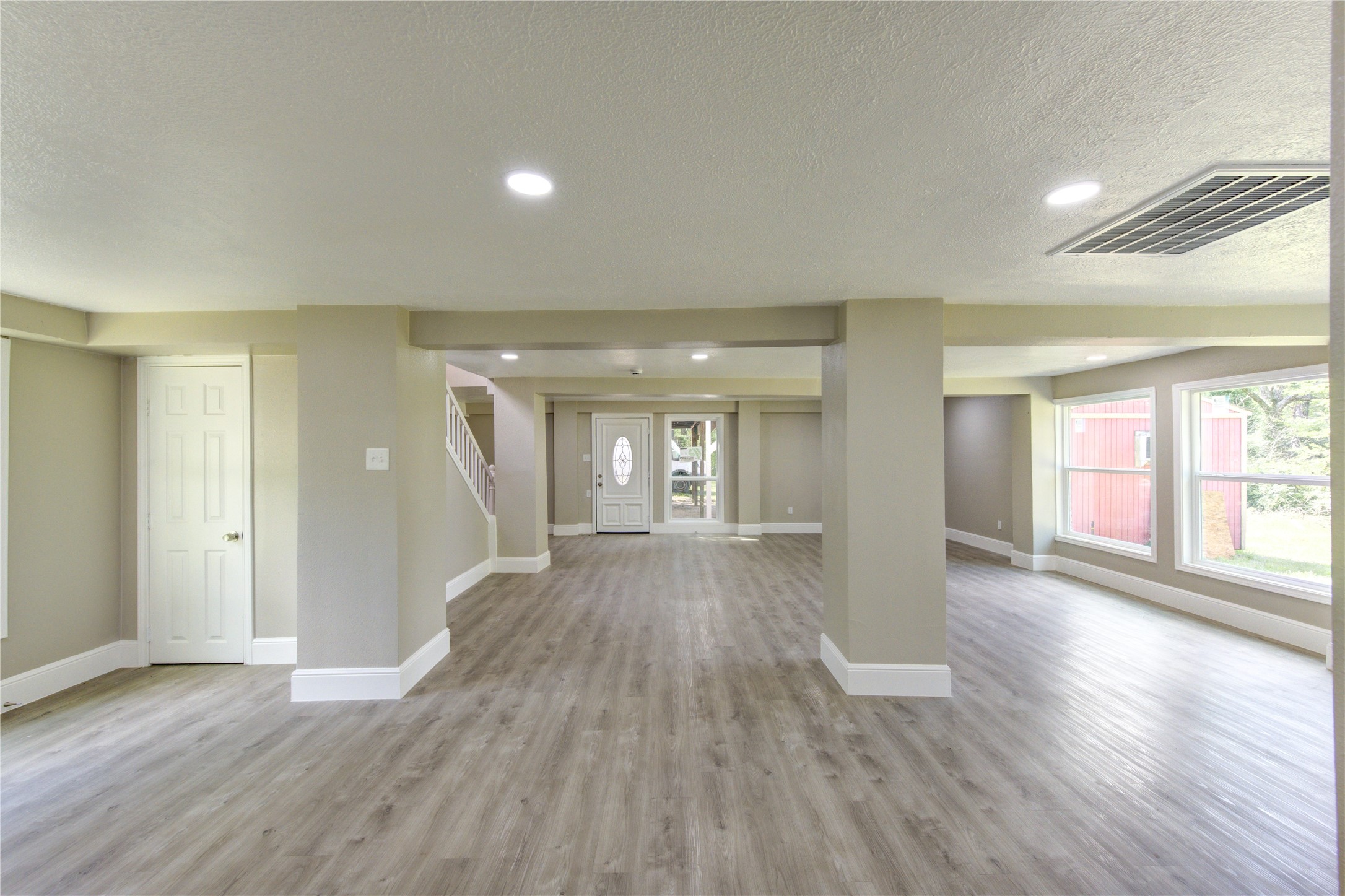 15170 McRae Lake Conroe, TX 77303 - Photo 7 of 25 wooden floor in an empty room with a window
