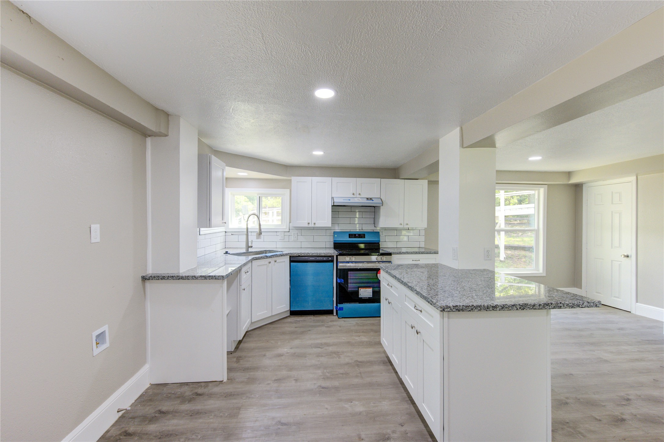 15170 McRae Lake Conroe, TX 77303 - Photo 9 of 25 a large kitchen with kitchen island granite countertop a sink and cabinets