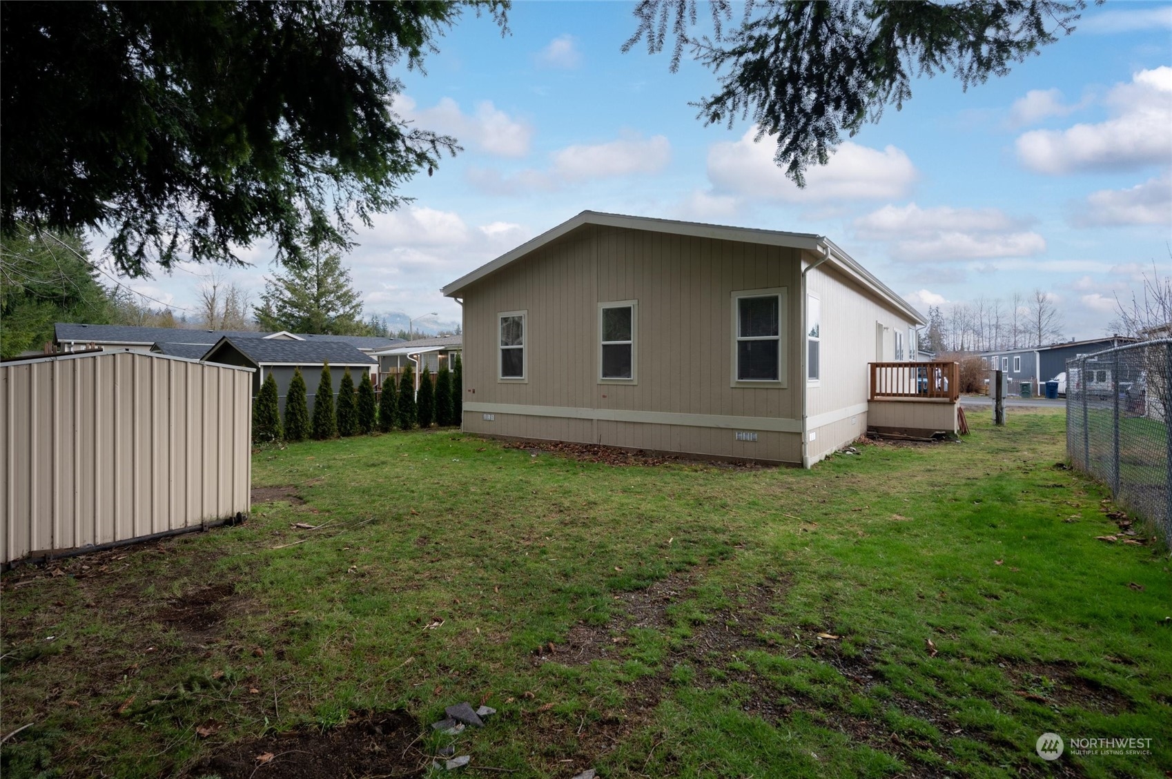 700 North Reed Street, Unit 21 Sedro-Woolley, WA 98284 - Photo 1 of 28 a house with green field in front of it