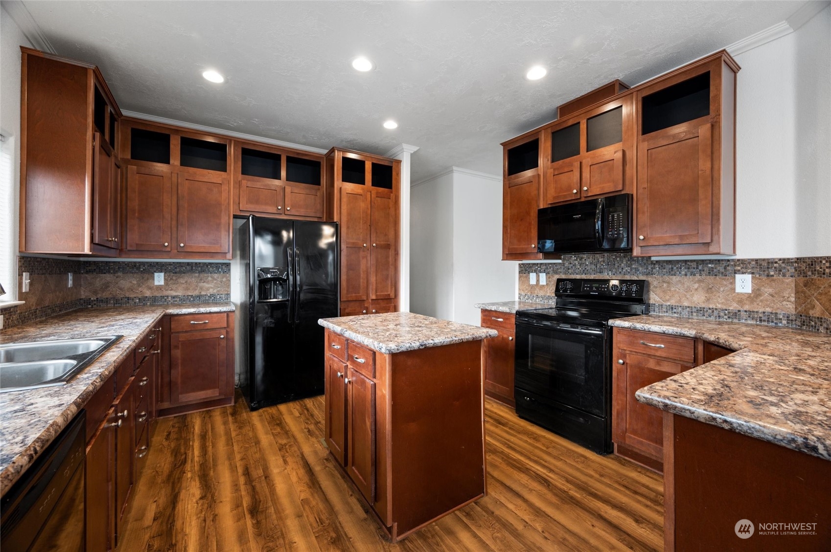 700 North Reed Street, Unit 21 Sedro-Woolley, WA 98284 - Photo 11 of 28 a kitchen with stainless steel appliances granite countertop a stove top oven a sink and a refrigerator