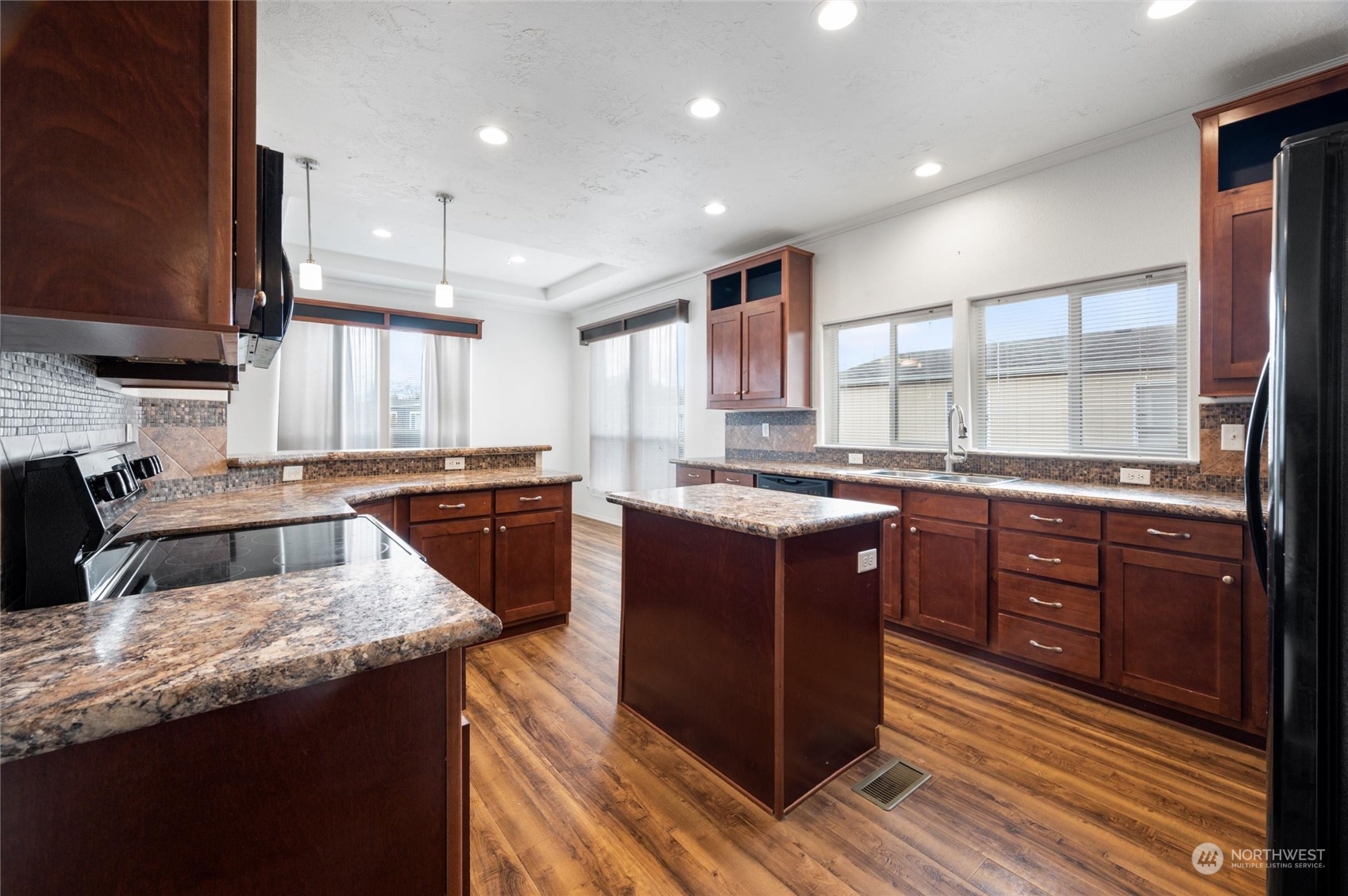 700 North Reed Street, Unit 21 Sedro-Woolley, WA 98284 - Photo 12 of 28 a kitchen with stainless steel appliances granite countertop wooden cabinets a sink and a stove