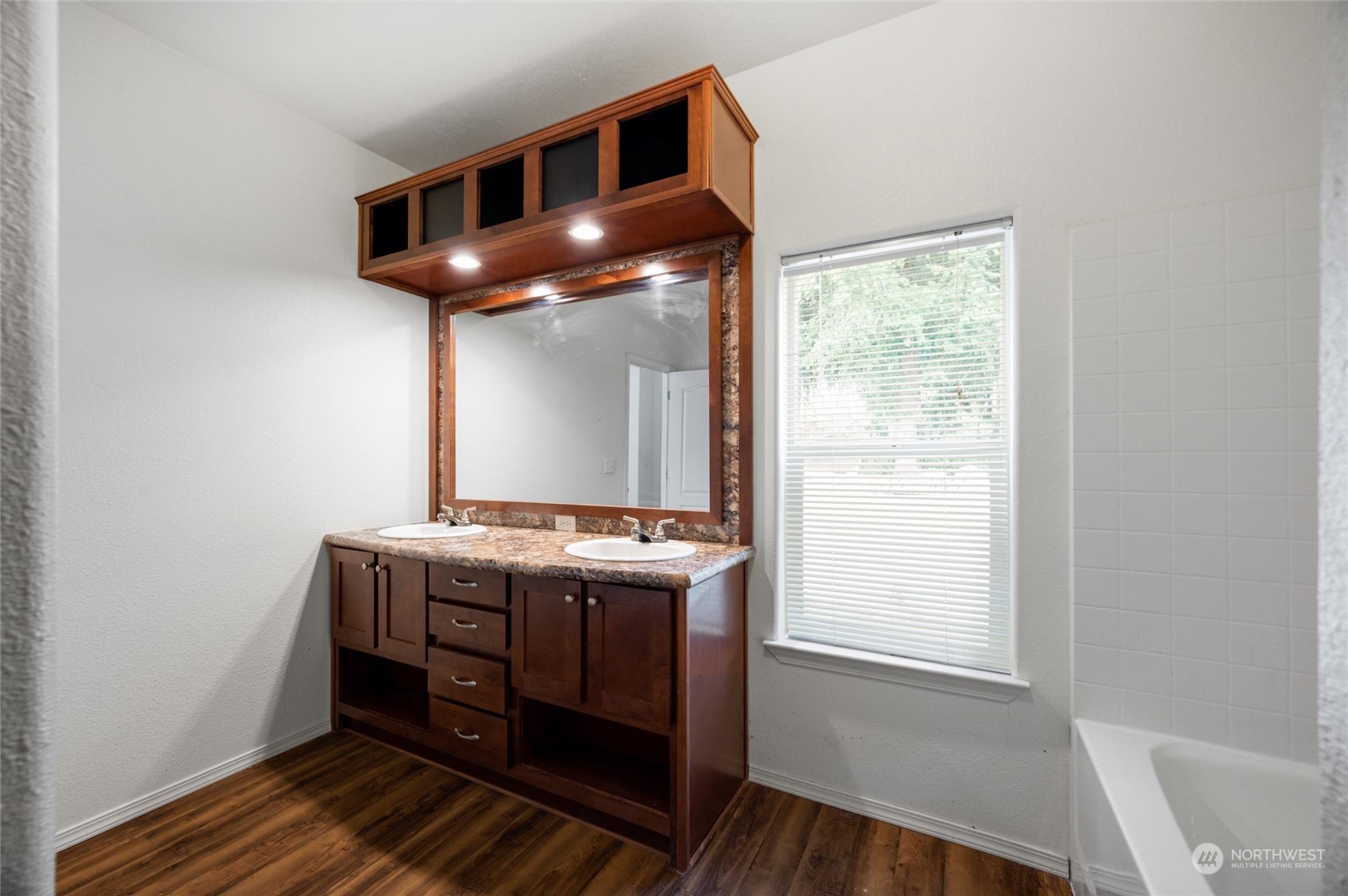 700 North Reed Street, Unit 21 Sedro-Woolley, WA 98284 - Photo 17 of 28 a room with wooden floor and furniture