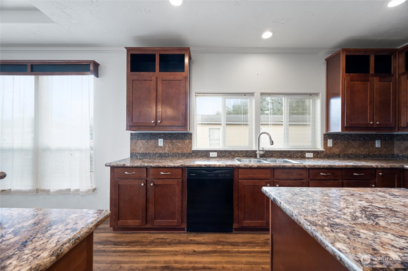 700 North Reed Street, Unit 21 Sedro-Woolley, WA 98284 - Photo 10 of 28 a kitchen with kitchen island granite countertop wooden cabinets and a counter top space
