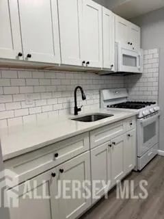 a kitchen with white cabinets and a sink