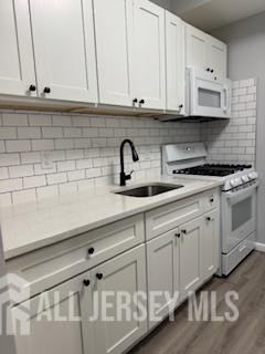 118 West 2nd Avenue, Unit 4 Roselle, NJ 07203 - Photo 6 of 12 a kitchen with white cabinets and a sink