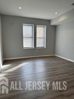 118 West 2nd Avenue, Unit 4 Roselle, NJ 07203 - Photo 7 of 12 a view of wooden floor and windows in a room