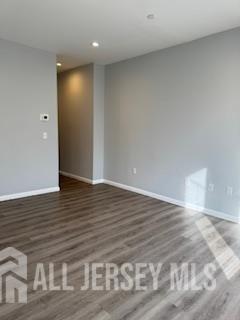 118 West 2nd Avenue, Unit 4 Roselle, NJ 07203 - Photo 8 of 12 a view of an empty room with wooden floor and closet