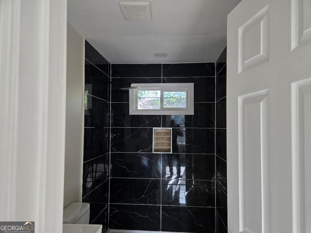 74 Carver Road McDonough, GA 30253 - Photo 11 of 19 a bathroom with a glass shower door