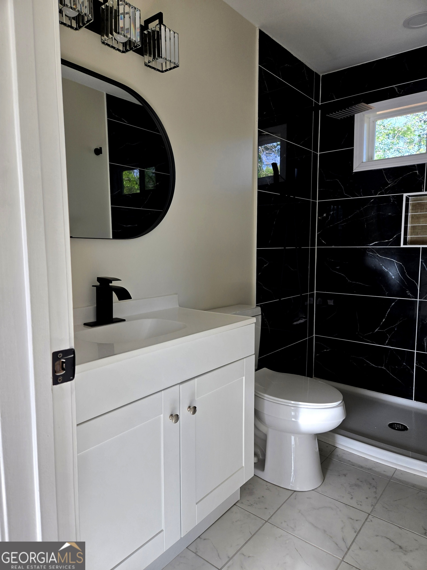 74 Carver Road McDonough, GA 30253 - Photo 13 of 19 a bathroom with a toilet a sink and shower