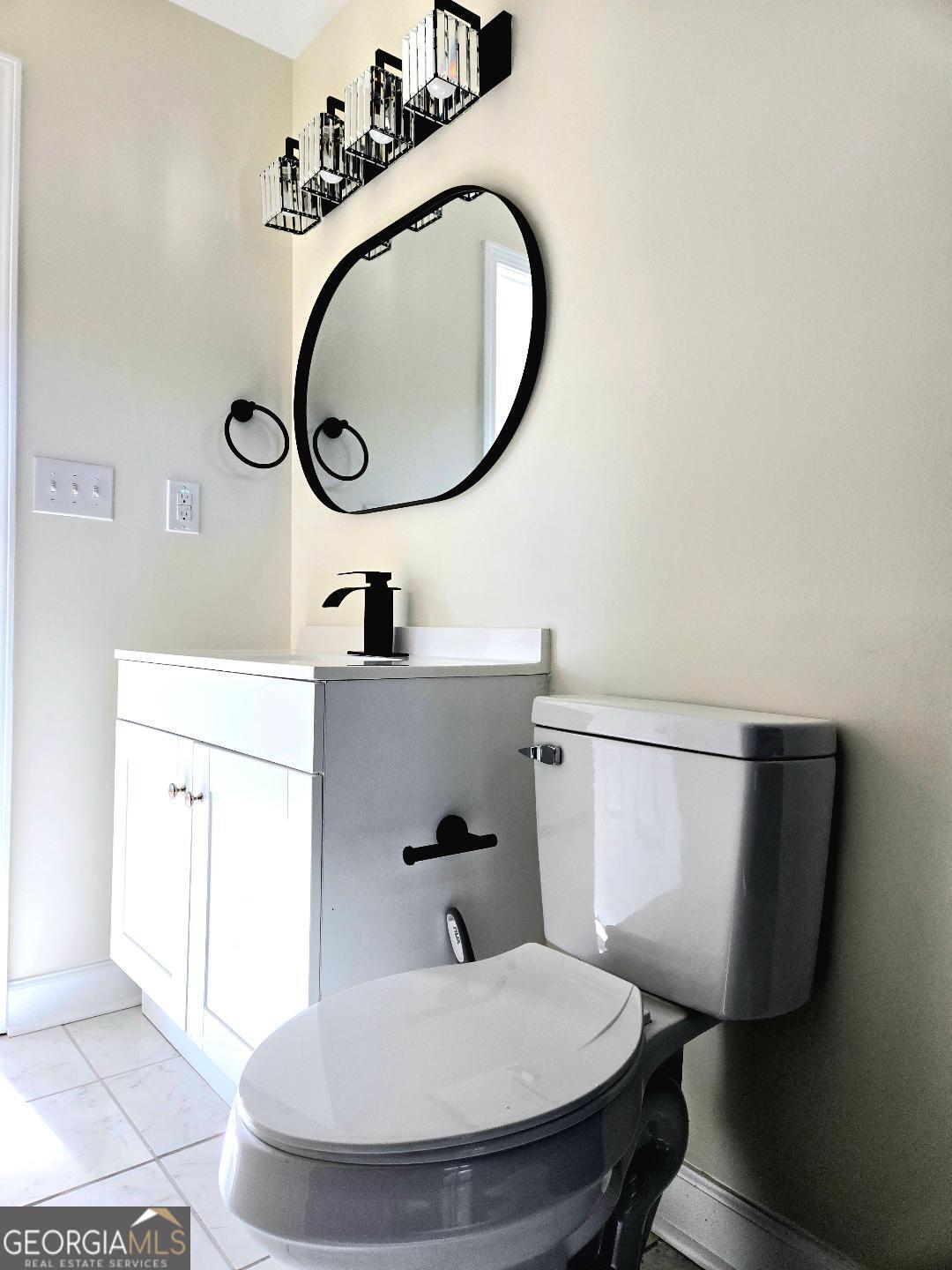 74 Carver Road McDonough, GA 30253 - Photo 14 of 19 a bathroom with a sink mirror and toilet