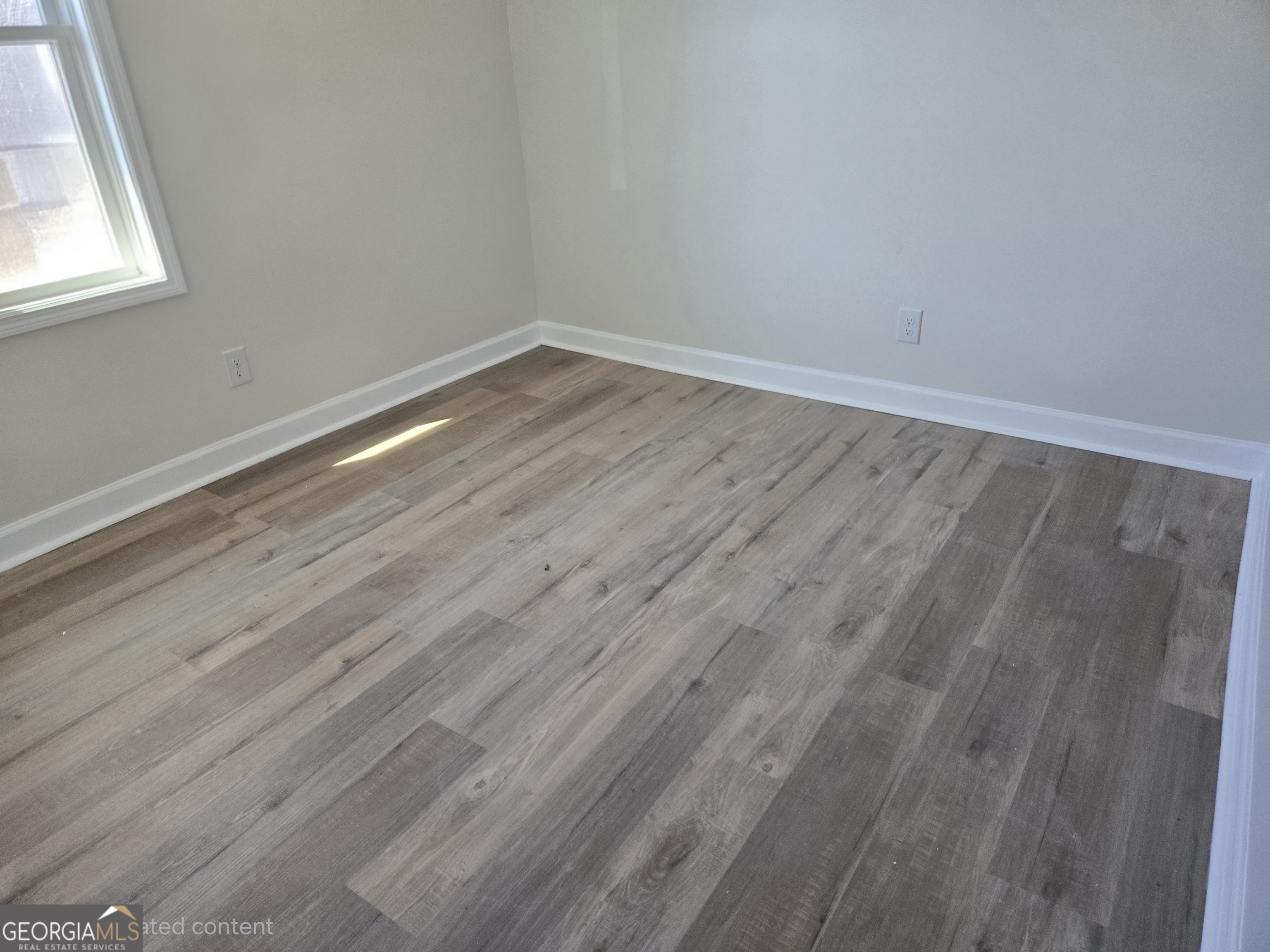 74 Carver Road McDonough, GA 30253 - Photo 16 of 19 a view of a room that has wooden floor and large window