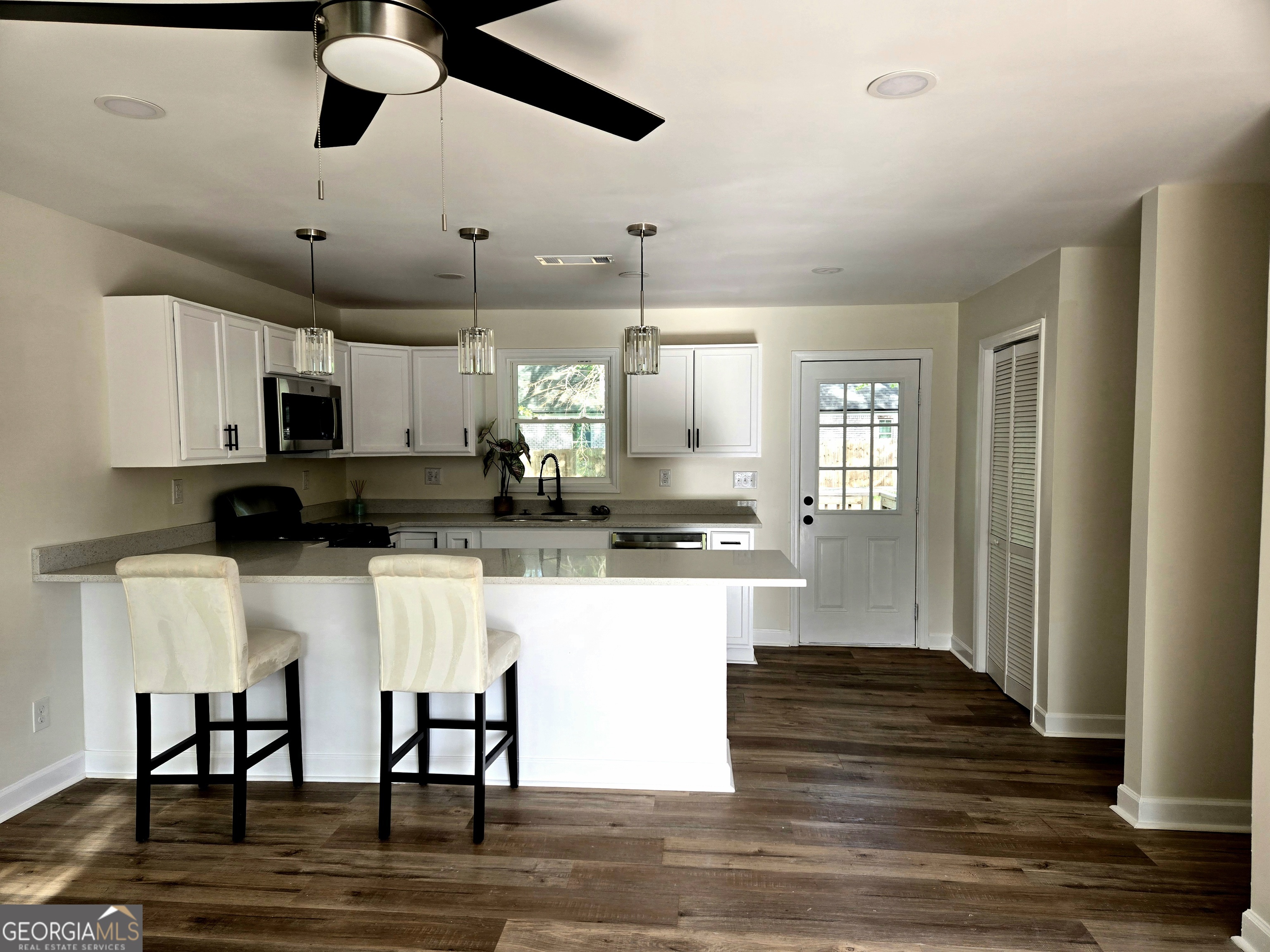 74 Carver Road McDonough, GA 30253 - Photo 5 of 19 a kitchen with stainless steel appliances kitchen island granite countertop a cabinets and wooden floor