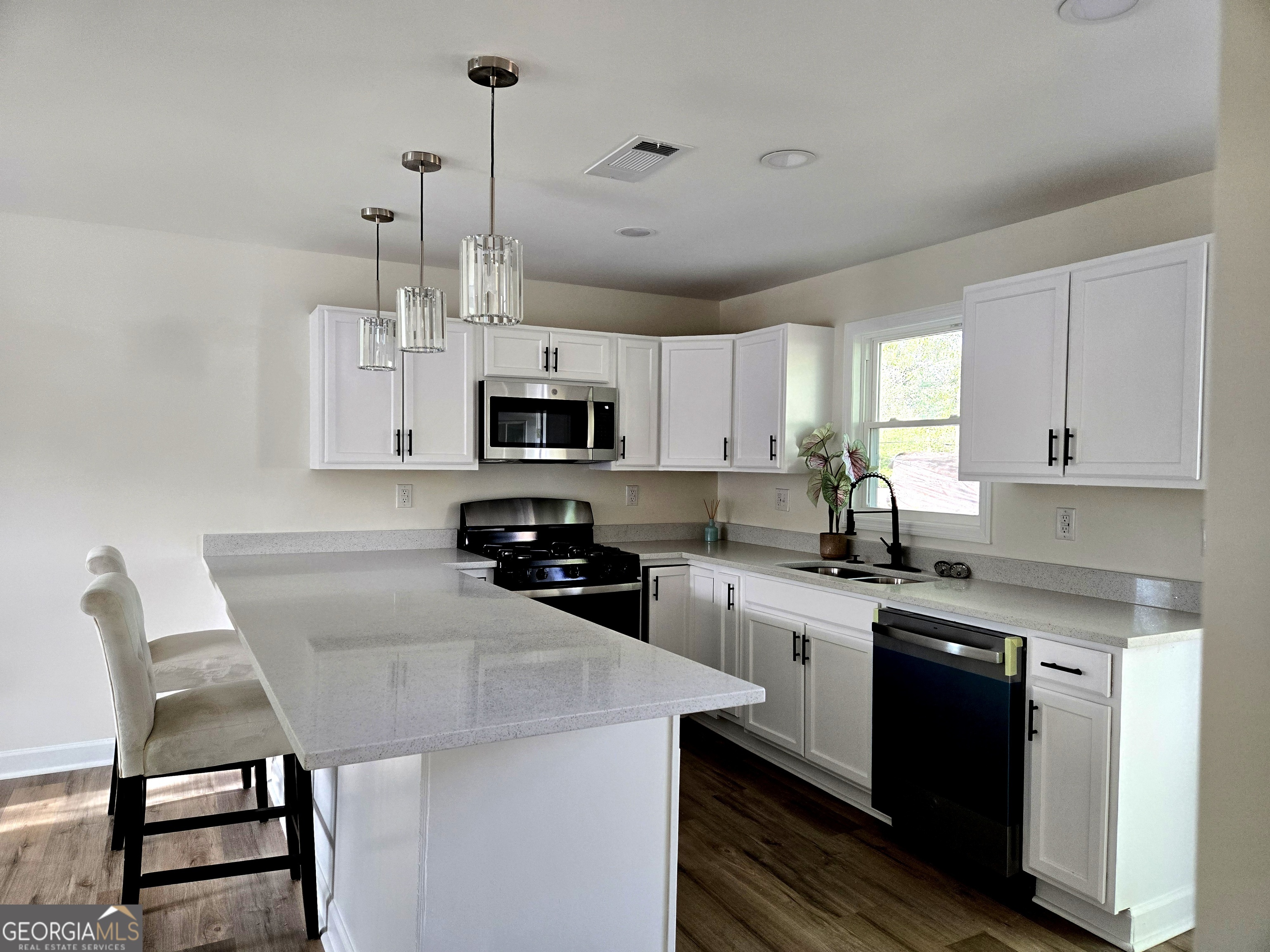 74 Carver Road McDonough, GA 30253 - Photo 6 of 19 a kitchen with stainless steel appliances kitchen island a white cabinets and wooden floor