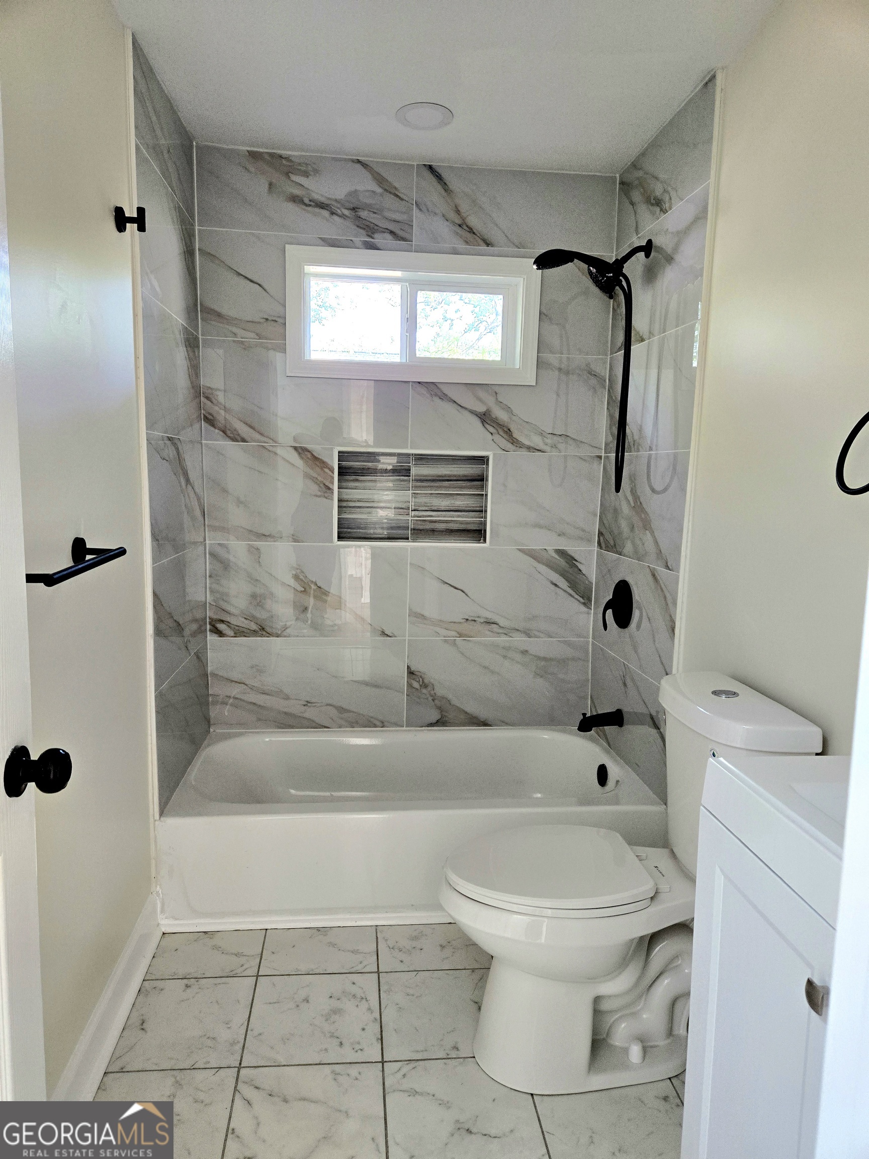 74 Carver Road McDonough, GA 30253 - Photo 8 of 19 a bathroom with a toilet and a shower