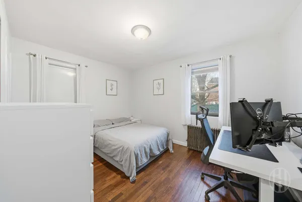 a bedroom with a bed and a desk