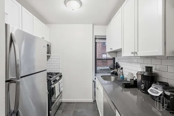 a kitchen with a refrigerator and a sink