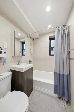 a bathroom with a sink a toilet and a bathtub