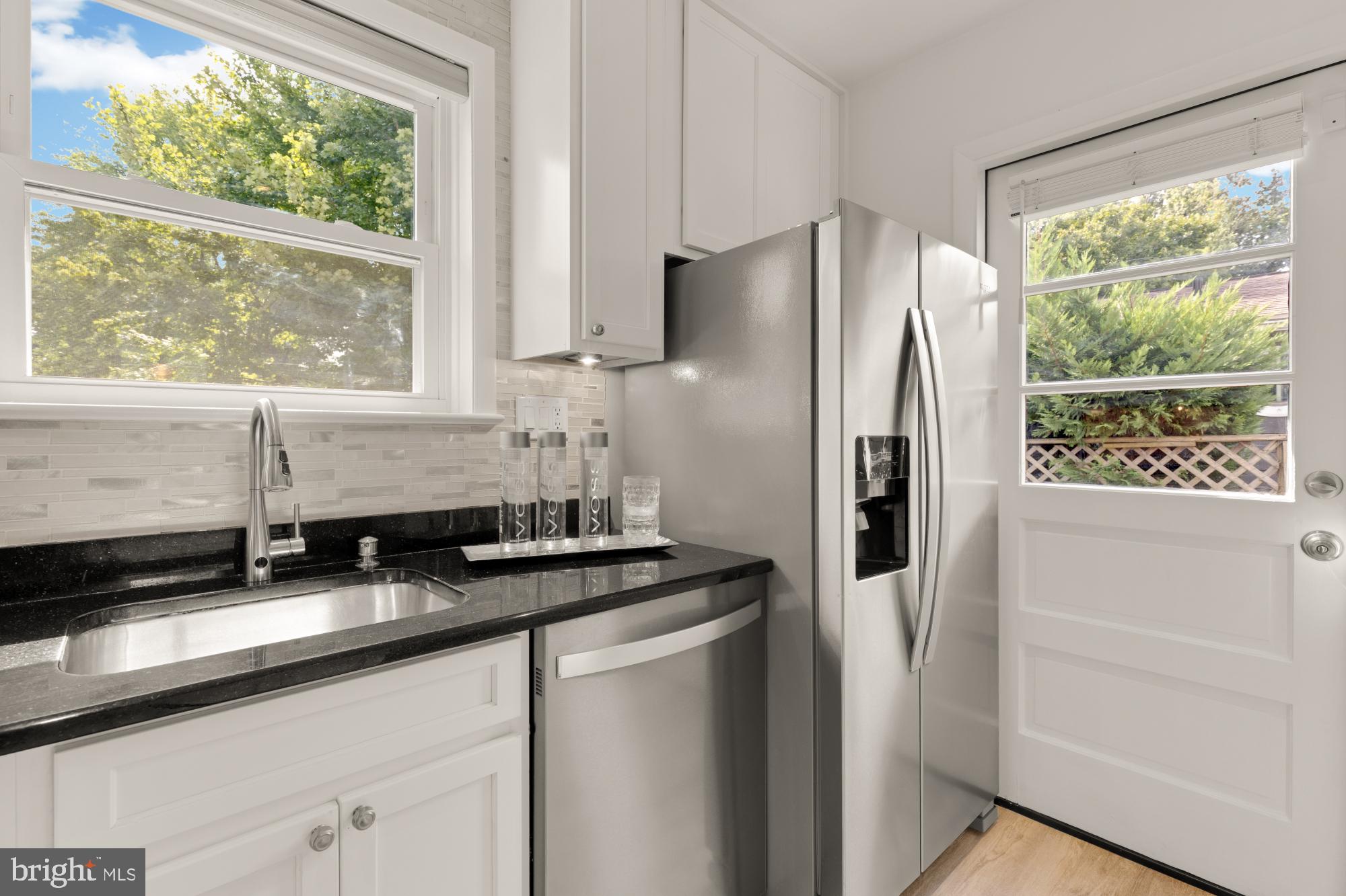 9811 Dallas Avenue Silver Spring, MD 20901 - Photo 13 of 45 a kitchen with stainless steel appliances granite countertop a refrigerator and a sink