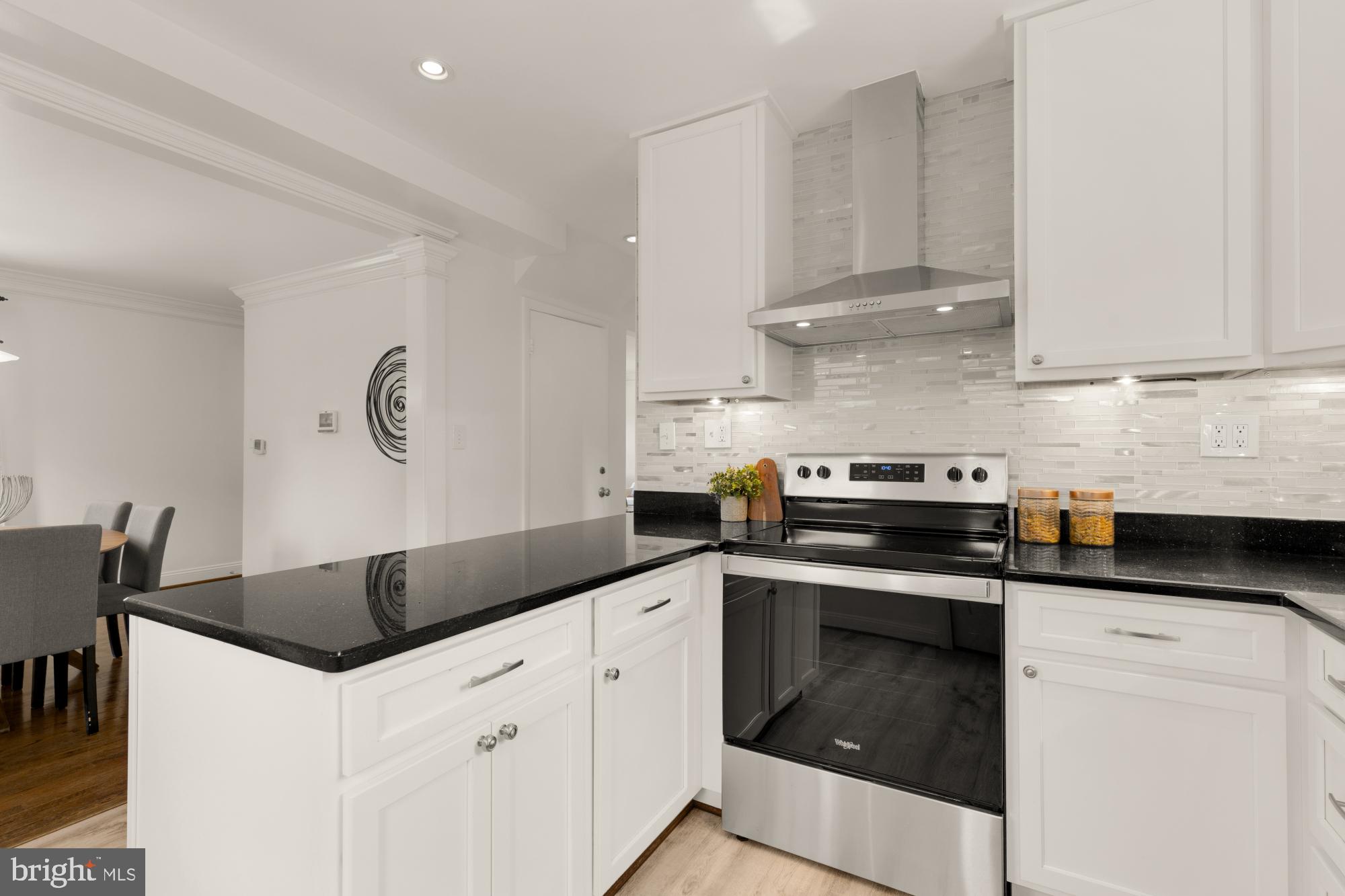 9811 Dallas Avenue Silver Spring, MD 20901 - Photo 14 of 45 a kitchen with granite countertop white cabinets and a stove
