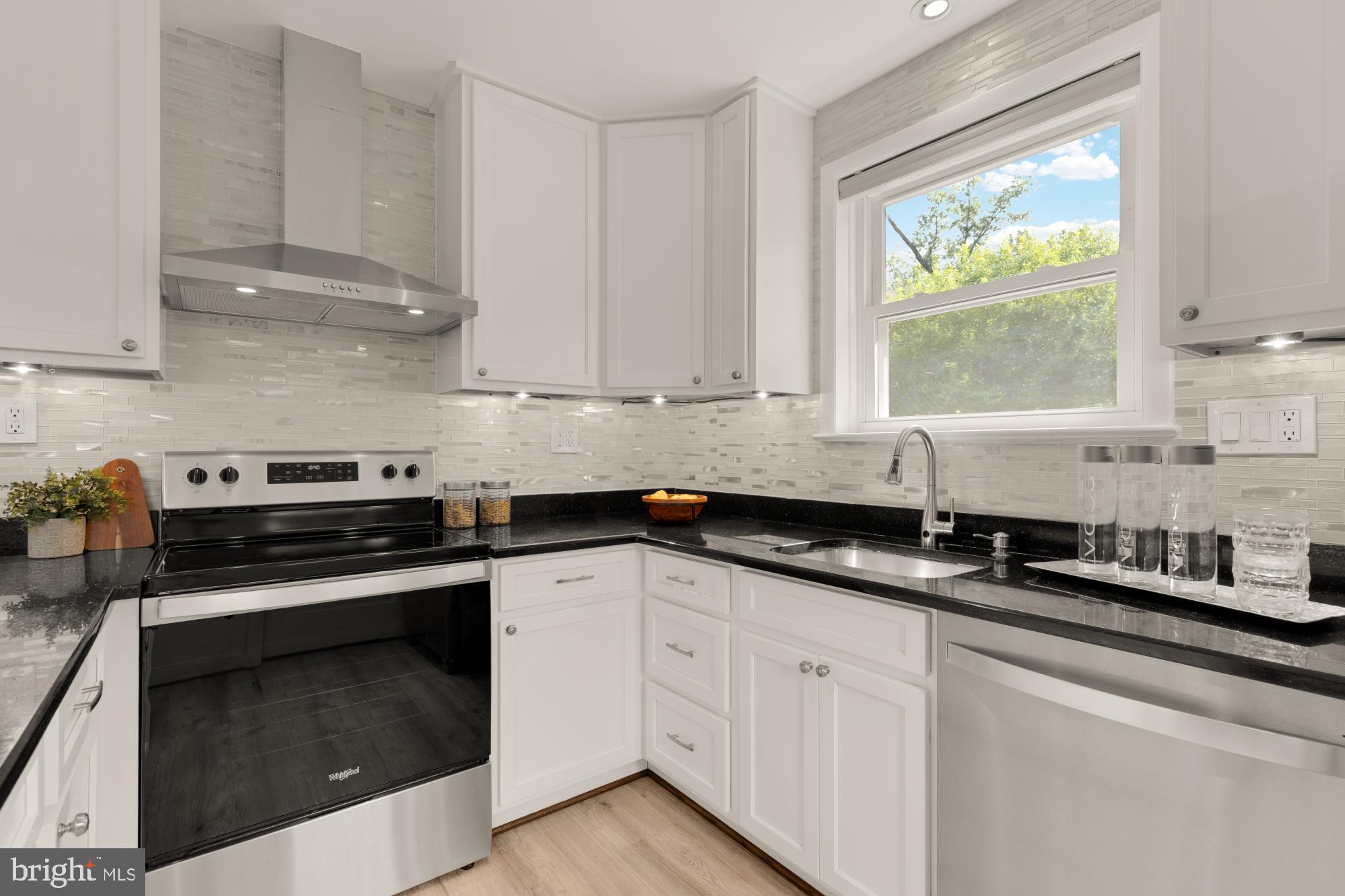 9811 Dallas Avenue Silver Spring, MD 20901 - Photo 15 of 45 a kitchen with granite countertop white cabinets and a stove