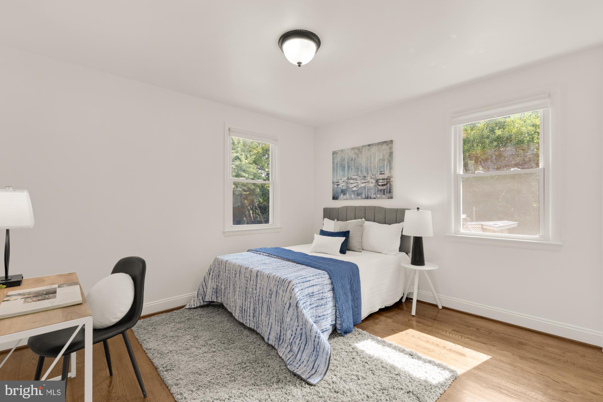 9811 Dallas Avenue Silver Spring, MD 20901 - Photo 19 of 45 a bedroom with a bed and a table with windows