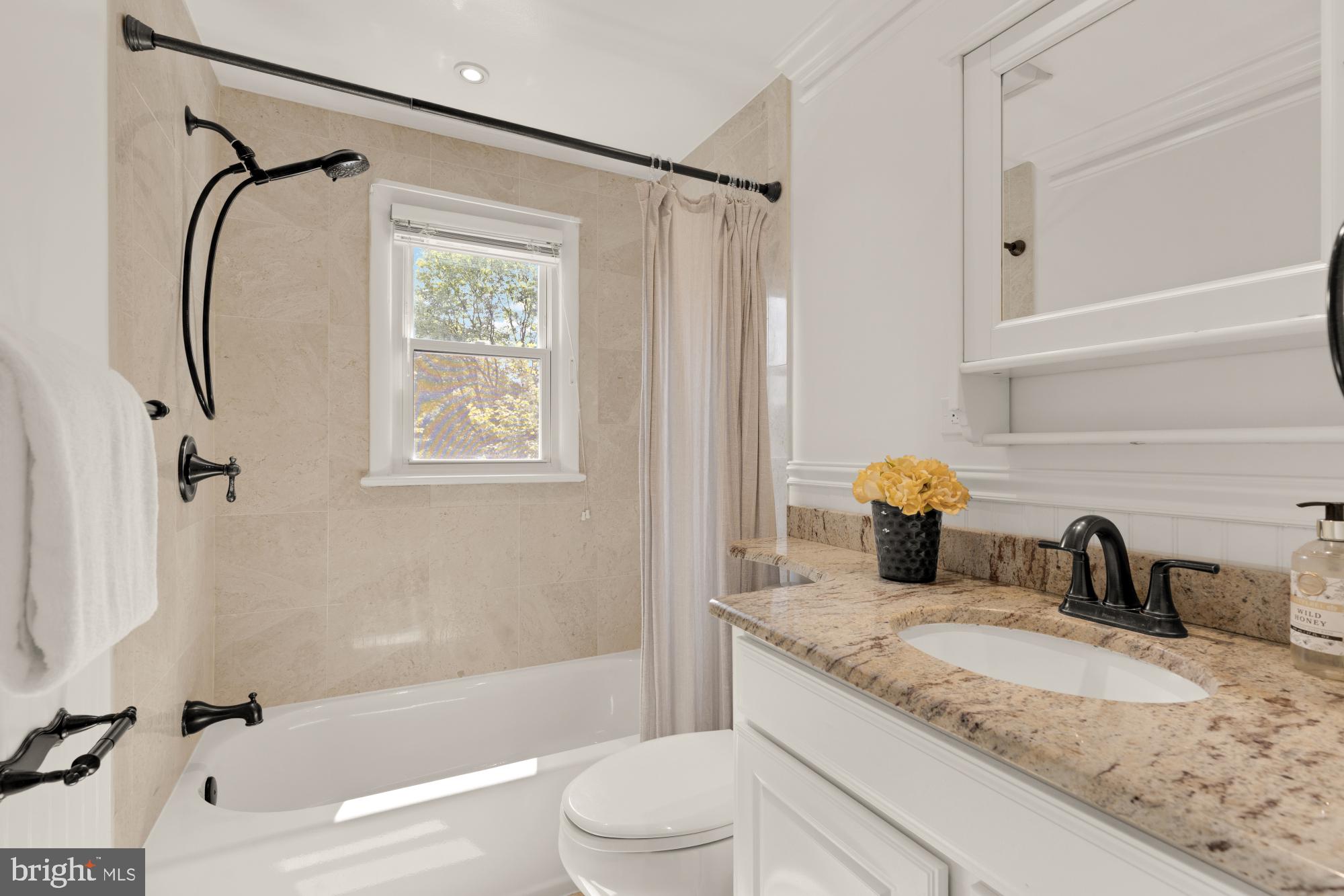 9811 Dallas Avenue Silver Spring, MD 20901 - Photo 20 of 45 a bathroom with a granite countertop sink toilet and shower