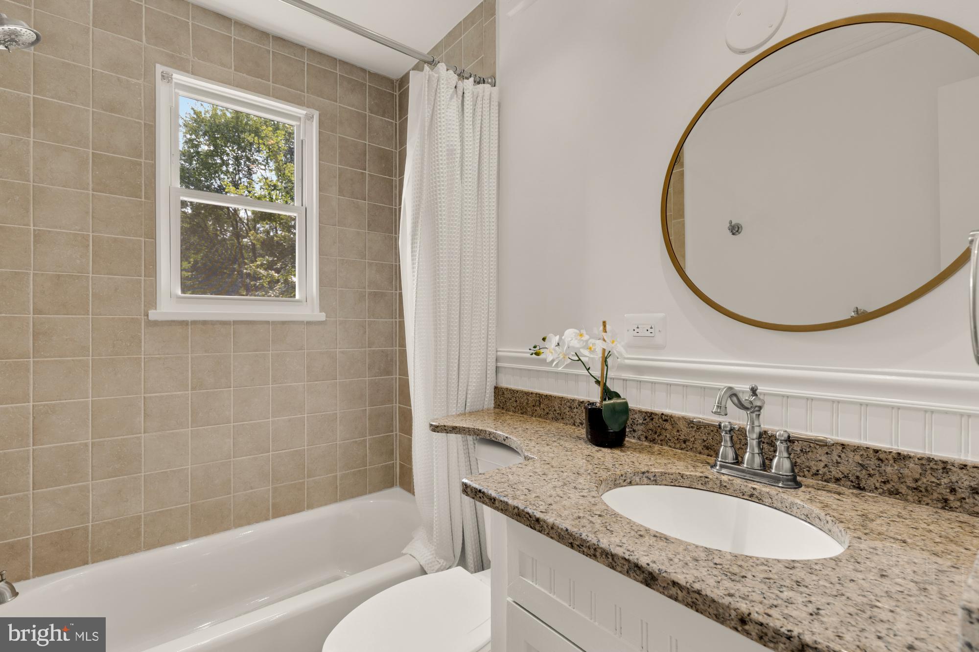 9811 Dallas Avenue Silver Spring, MD 20901 - Photo 30 of 45 a bathroom with a granite countertop sink and a mirror