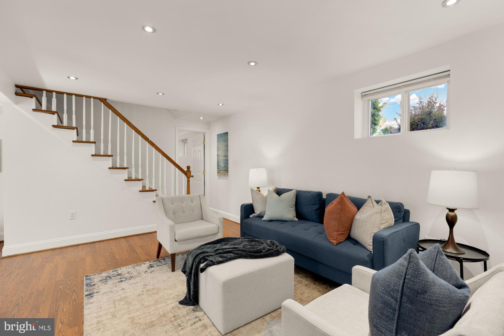 9811 Dallas Avenue Silver Spring, MD 20901 - Photo 31 of 45 a living room with furniture and a lamp with wooden floor