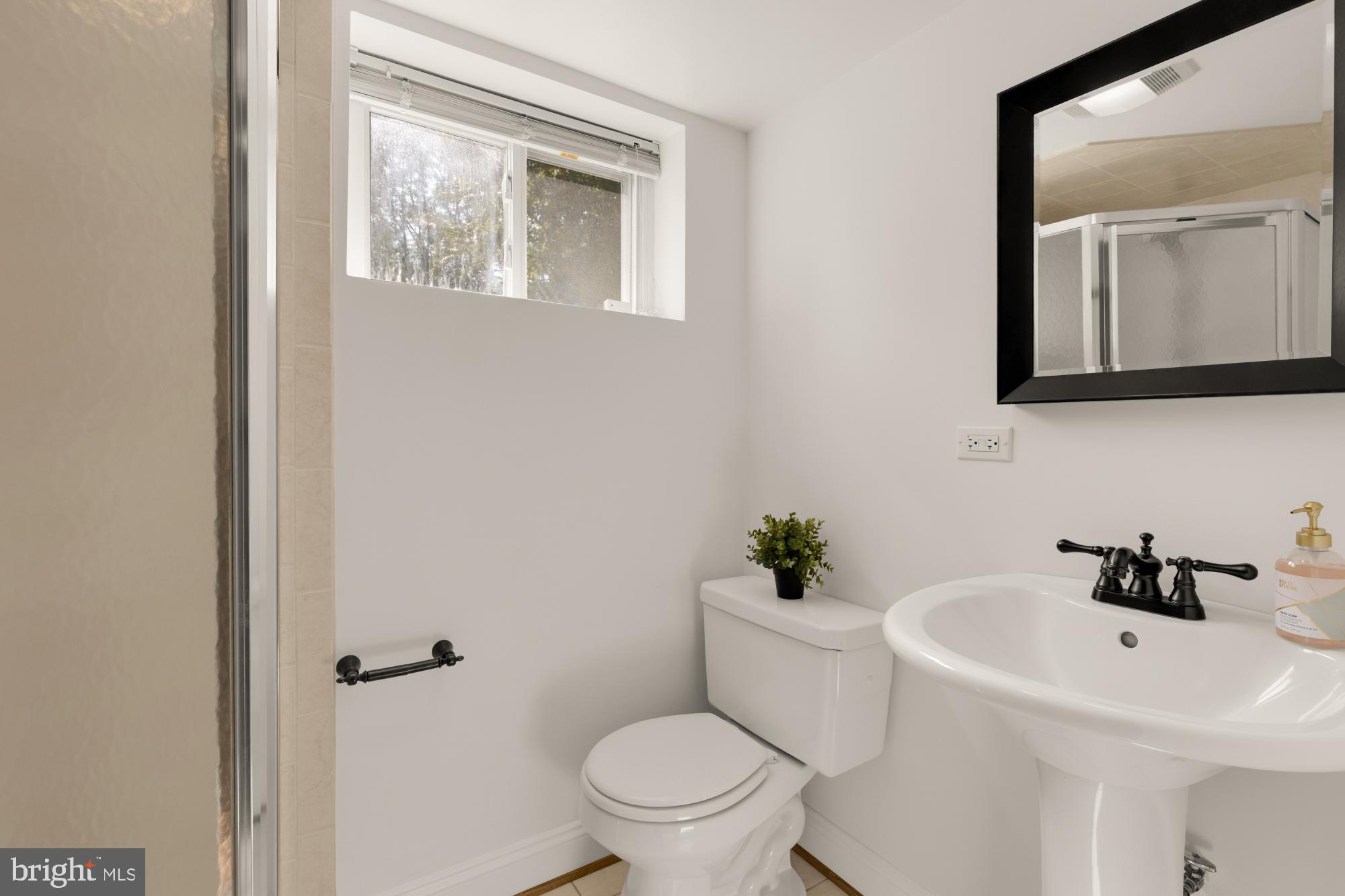 9811 Dallas Avenue Silver Spring, MD 20901 - Photo 35 of 45 a bathroom with a sink a mirror and a toilet