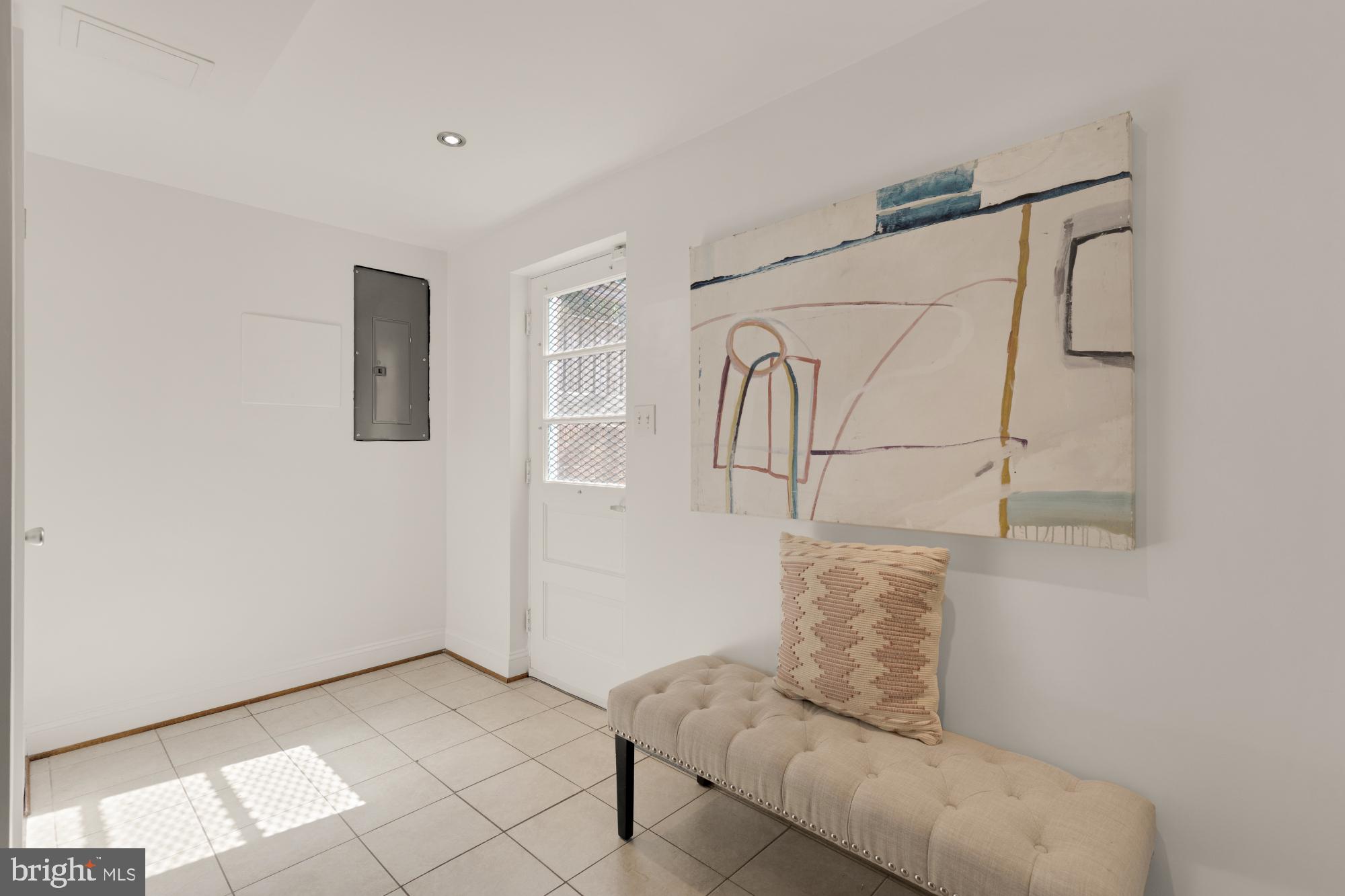 9811 Dallas Avenue Silver Spring, MD 20901 - Photo 39 of 45 a living room with furniture and a floor to ceiling window