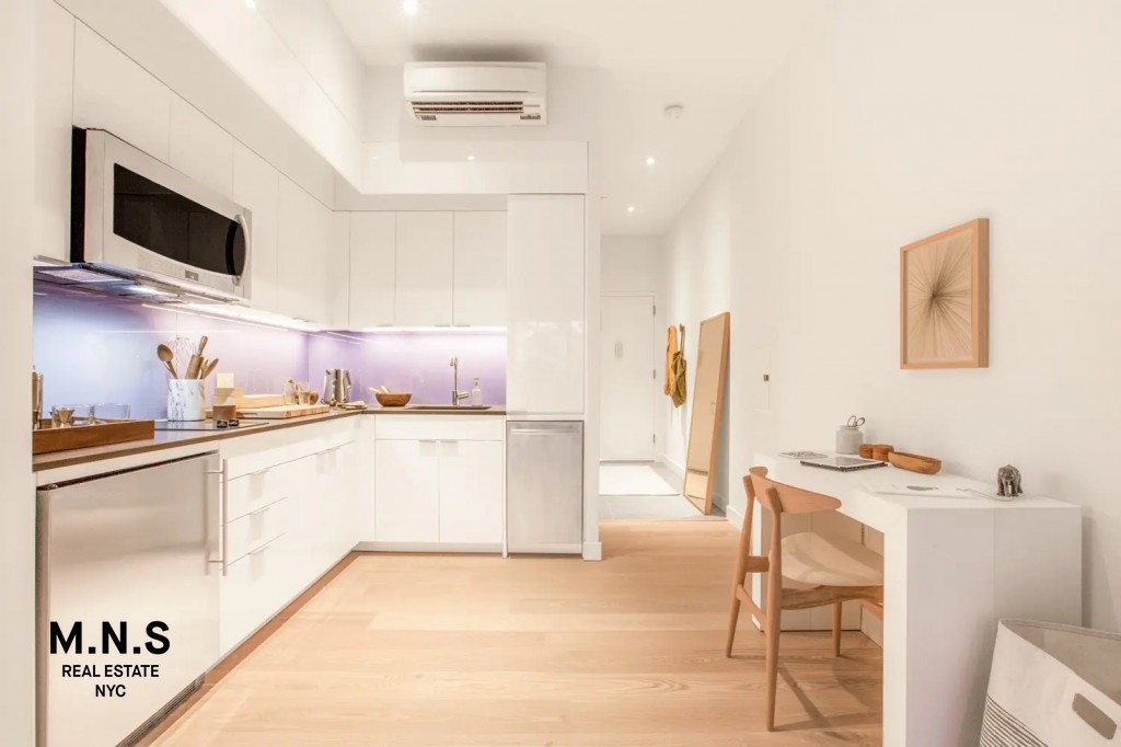 335 East 27th Street, Unit 9A Manhattan, NY 10016 - Photo 3 of 11 a kitchen with a sink cabinets and wooden floor