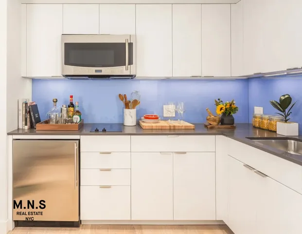 a kitchen with stainless steel appliances a sink and a microwave