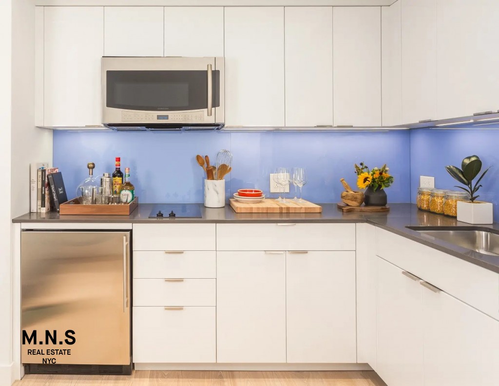 335 East 27th Street, Unit 9A Manhattan, NY 10016 - Photo 6 of 11 a kitchen with stainless steel appliances white cabinets and a sink
