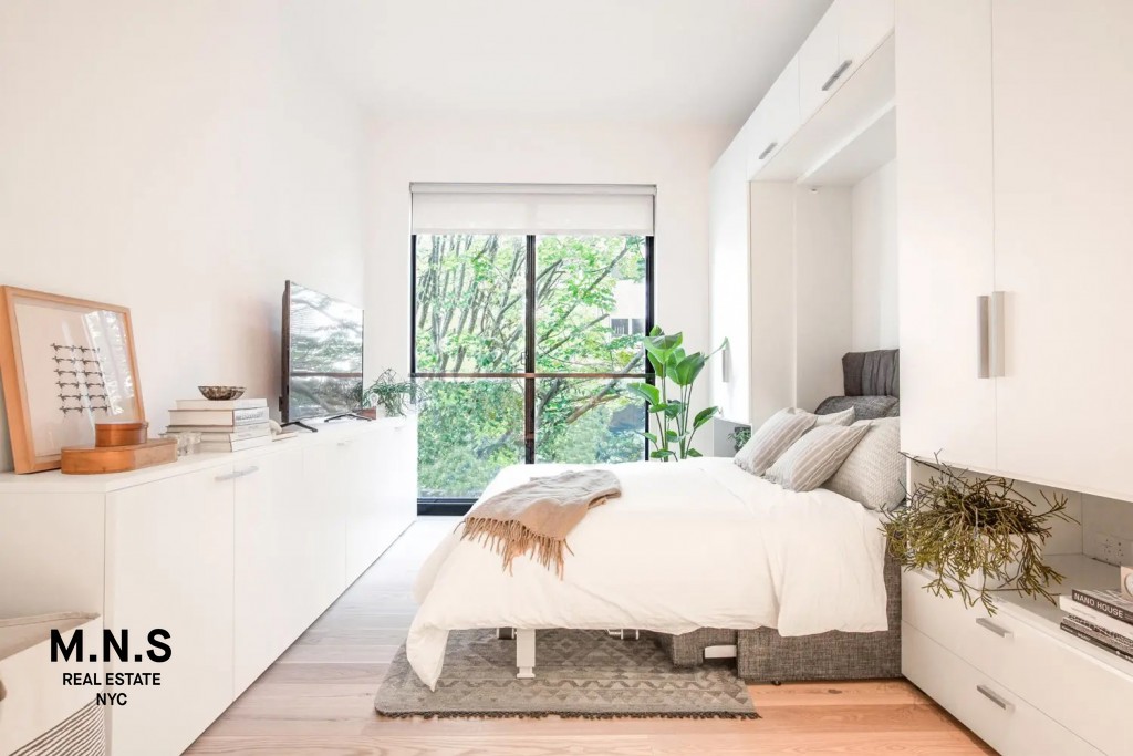 335 East 27th Street, Unit 9A Manhattan, NY 10016 - Photo 7 of 11 a large white bed sitting in a bedroom next to a window