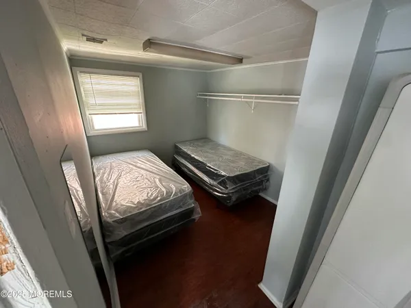 a bedroom with bed and a window