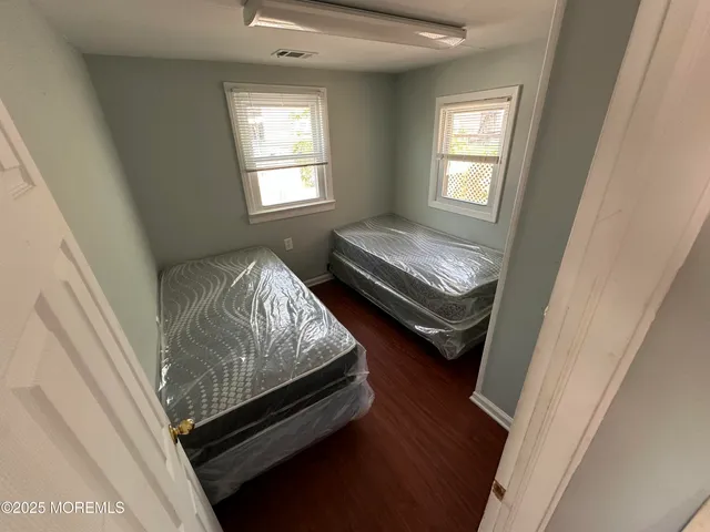 a bed sitting in a bedroom next to a window