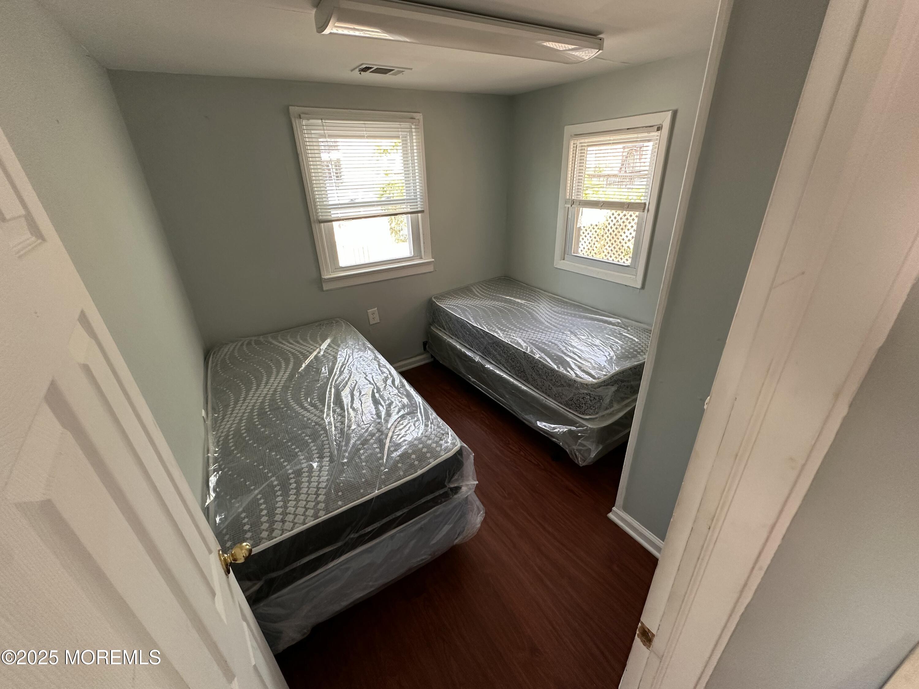 116 12th Avenue, Unit B Belmar, NJ 07719 - Photo 5 of 5 a bed sitting in a bedroom next to a window