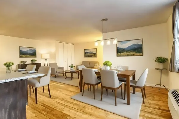a view of a dining room with furniture and wooden floor