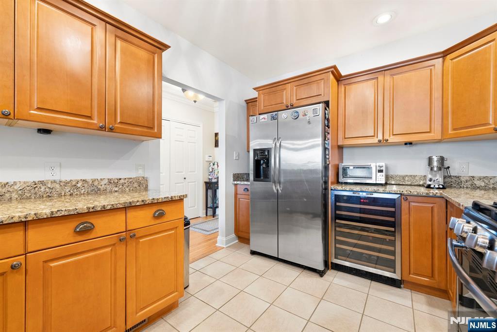 108 The Promenade, Unit 108 Edgewater, NJ 07020 - Photo 11 of 49 a kitchen with stainless steel appliances granite countertop a refrigerator and a stove top oven