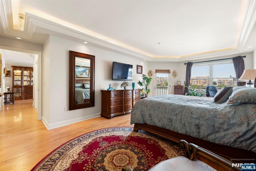 108 The Promenade, Unit 108 Edgewater, NJ 07020 - Photo 24 of 49 a bed room with a bed and a television