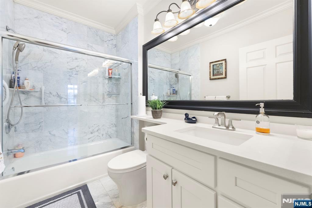 108 The Promenade, Unit 108 Edgewater, NJ 07020 - Photo 38 of 49 a bathroom with a sink a toilet and a bathtub